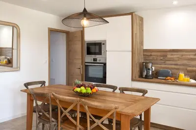 a kitchen with a wooden table with a bowl of fruit on it at Villa 
