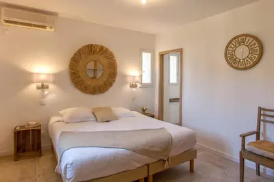 a bedroom with a bed and a mirror on the wall at Villa 