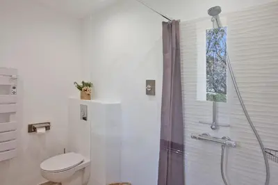 a bathroom with a shower and a toilet in it at Villa 