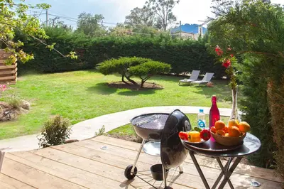 a table with a bowl of fruit and a drink on it at Villa 