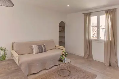 a living room with a couch and a window at Villa 