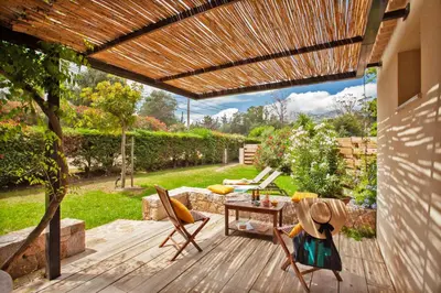a patio with a wooden deck with a wooden pergola at Villa 