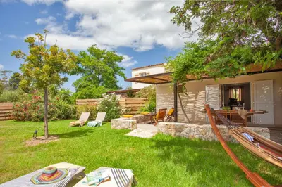 a backyard with a hammock and a house at Villa 
