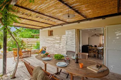 a patio with a wooden table and a dining room at Villa 