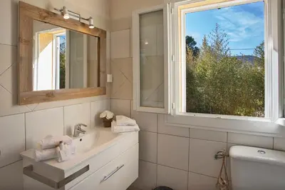a bathroom with a sink and a window at Maisonnette une chambre 
