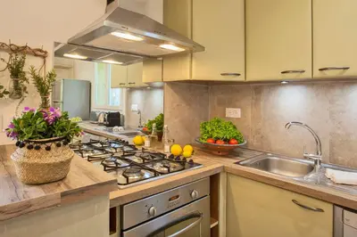 a kitchen with a stove and a sink at Maisonnette 