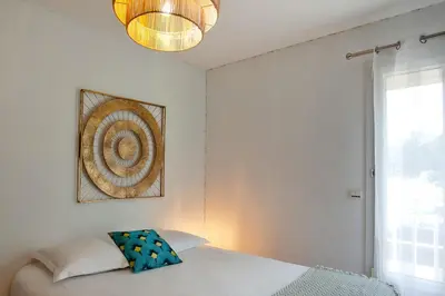 a bedroom with a bed and a picture on the wall at Appartement 