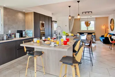 a kitchen with a large island in the middle of a room at Appartement 