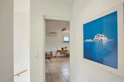 a living room with a large tv hanging on a wall at Appartement 