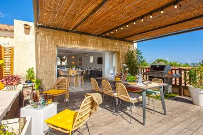 a patio with a table and chairs and a grill at Appartement 