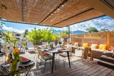 a patio with a table and chairs on a deck at Appartement 