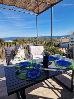a blue table with plates and glasses on it at Vista Mare- proche plage et commerces - 8 pers in Sari Solenzara