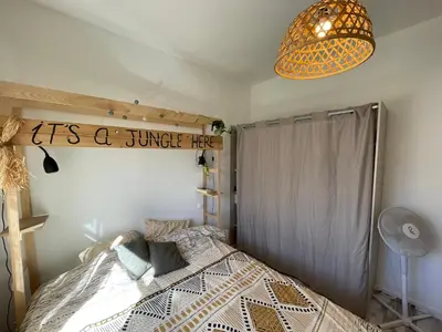 a bedroom with a bed and a pendant light at Vista Mare- proche plage et commerces - 8 pers in Sari Solenzara