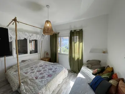 a bedroom with a canopy bed and a window at Vista Mare- proche plage et commerces - 8 pers in Sari Solenzara