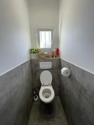 a small bathroom with a toilet with a window at Vista Mare- proche plage et commerces - 8 pers in Sari Solenzara