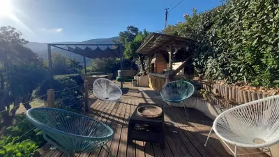 a deck with three chairs and a table at Villa T4 à Campomoro corse du sud, 800m plage in Belvédère