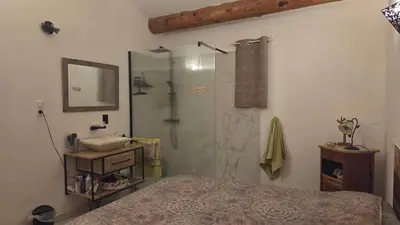 a bathroom with a shower and a sink and a bed at Villa T4 à Campomoro corse du sud, 800m plage in Belvédère
