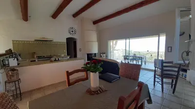 a kitchen and dining room with a table and chairs at Villa T4 à Campomoro corse du sud, 800m plage in Belvédère