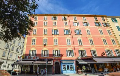 a large orange building on the side of a street at Awesome Apartment In Ajaccio With Wifi in Ajaccio
