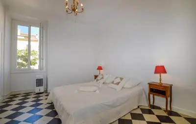 a white bedroom with a bed and a window at Awesome Apartment In Ajaccio With Wifi in Ajaccio