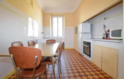 a kitchen with a table and chairs in a room at Awesome Apartment In Ajaccio With Wifi in Ajaccio