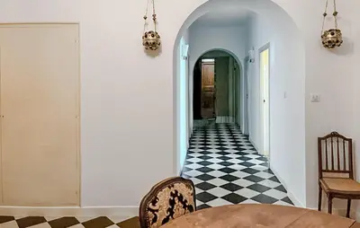 a hallway with a black and white checkered floor at Awesome Apartment In Ajaccio With Wifi in Ajaccio