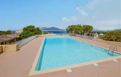 a swimming pool with a view of the water at 2 Bedroom Cozy Home In Grosseto-Prugna in Grosseto-Prugna