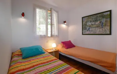 a bedroom with two beds and a window at 2 Bedroom Cozy Home In Grosseto-Prugna in Grosseto-Prugna