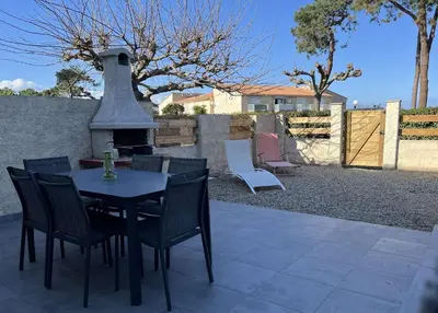 a patio with a table and chairs and a fireplace at BORGO Duplex 4 pers proche mer in Borgo