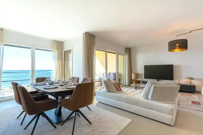 a living room with a table and a couch at Agosta: Terrace with sea view - Luxury flat | By Airnest in Albitreccia