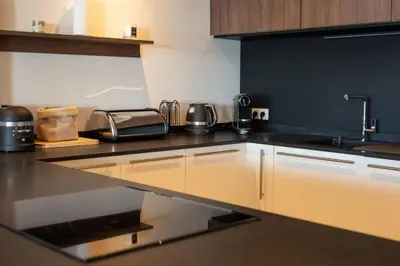 a kitchen with a sink and a counter top at Agosta: Terrace with sea view - Luxury flat | By Airnest in Albitreccia