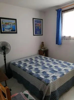 a bedroom with a blue and white bed in a room at Maison près de la plage in Penta-di-Casinca