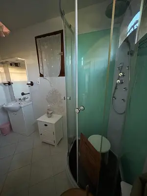 a bathroom with a shower and a sink at Maison près de la plage in Penta-di-Casinca