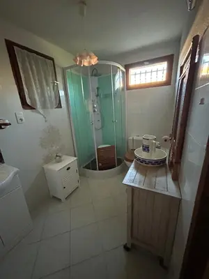 a bathroom with a shower and a toilet and a sink at Maison près de la plage in Penta-di-Casinca