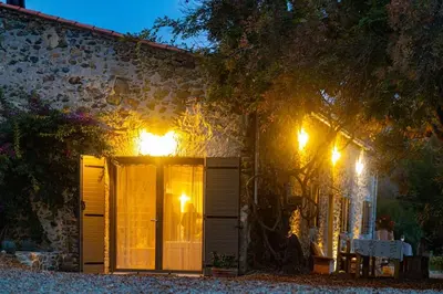 a house with lights on the side of it at Demeure de charme Suarella Domaine de Marquiliani in Aghione