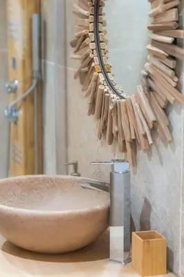 a bathroom with a sink and a mirror on the wall at Demeure de charme Suarella Domaine de Marquiliani in Aghione
