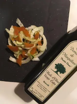 a black plate of food with vegetables on it at Demeure de charme Suarella Domaine de Marquiliani in Aghione