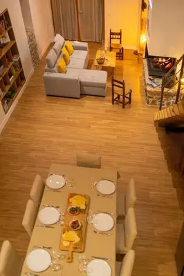 a living room with a table and a couch at Demeure de charme Suarella Domaine de Marquiliani in Aghione