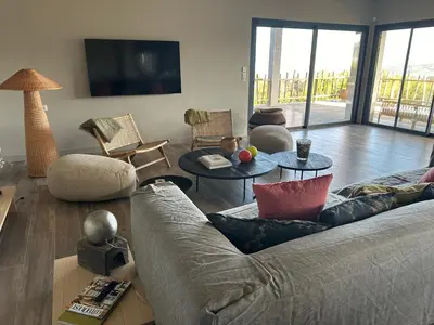 a living room with a couch and tables and a tv at Villa Casa di Simone Pietrosella Corse du Sud in Pietrosella