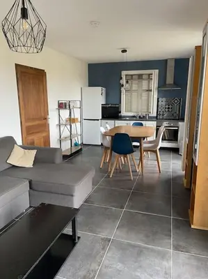 a kitchen with a couch and a table in a room at Bas de villa pour 6 in Venzolasca