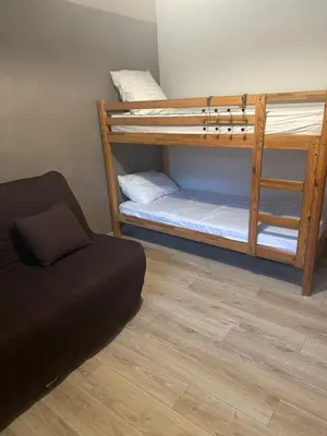 a room with two bunk beds and a couch at Bas de villa pour 6 in Venzolasca