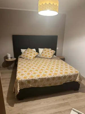 a bedroom with a bed with two pillows on it at Bas de villa pour 6 in Venzolasca