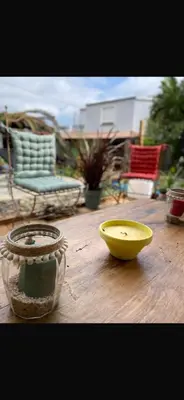 two vases sitting on a wooden deck with a yellow bowl at Maison familiale charmante in Borgo