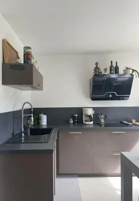 a kitchen with a sink and a microwave on the wall at Maison familiale charmante in Borgo