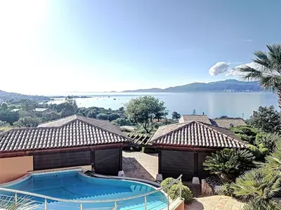 a house with a swimming pool and a view of the water at VILLA VUE MER in Pietrosella