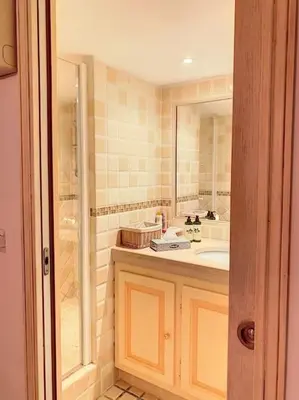 a bathroom with a sink and a shower at VILLA VUE MER in Pietrosella