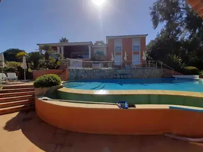 a house with a swimming pool in front of a house at VILLA VUE MER in Pietrosella