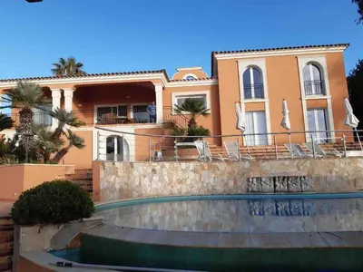 a house with a swimming pool in front of it at VILLA VUE MER in Pietrosella