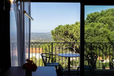 a view of a balcony with a table and chairs at Résidence Apa Nera in Calenzana