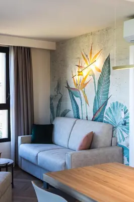 a living room with a couch and a painting on the wall at Résidence Apa Nera in Calenzana